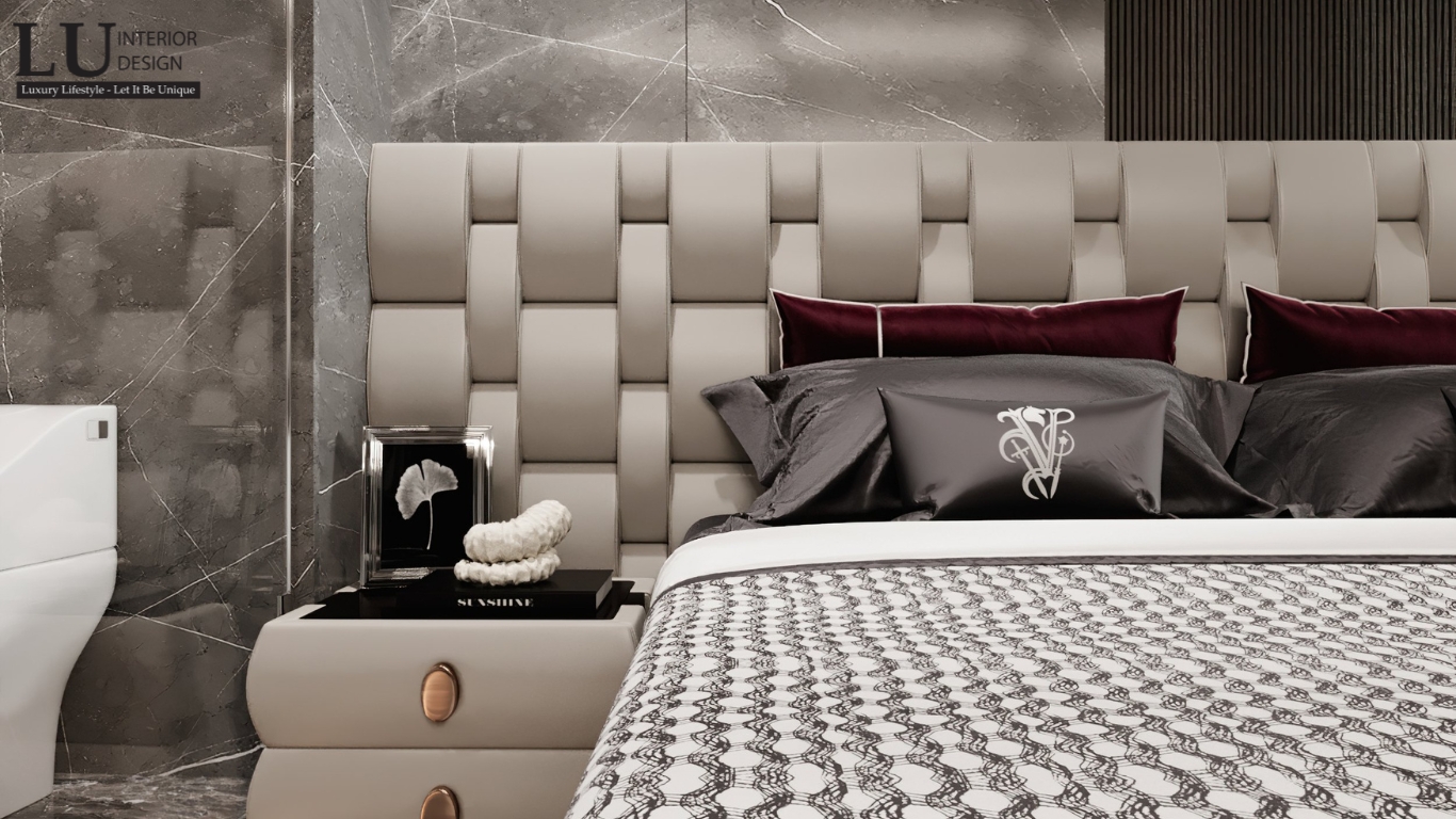 Thiết kế giường ngủ penthouse Vũng Tàu với vách đầu giường chần nút và decor đầu giường tone đỏ hiện đại
